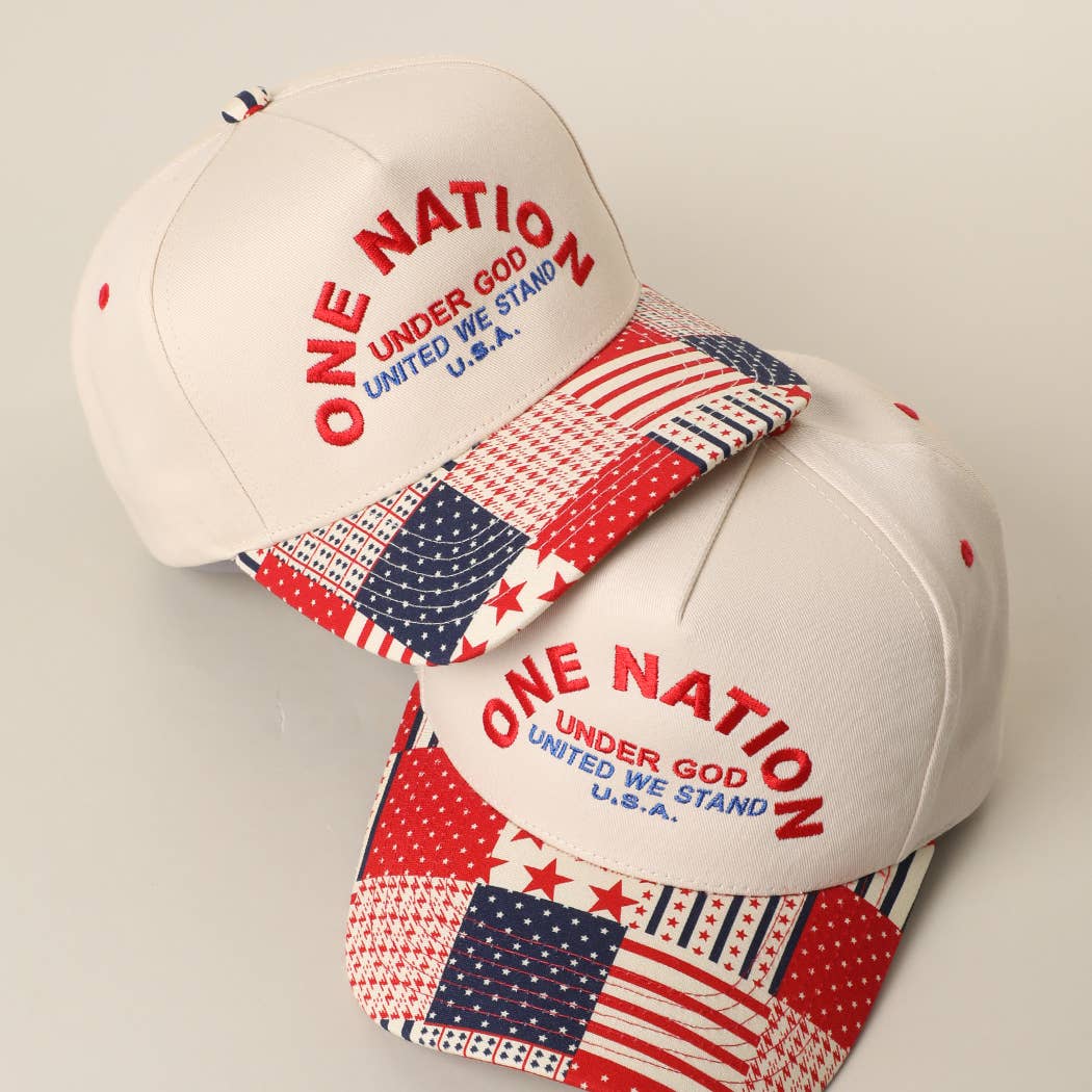 Two white baseball caps with American flag patterns and 'One Nation Under God' text on a light gray background.