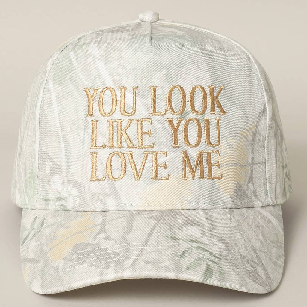 Cap with 'You Look Like You Love Me' text on a light background
