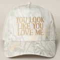 Cap with 'You Look Like You Love Me' text on a light background