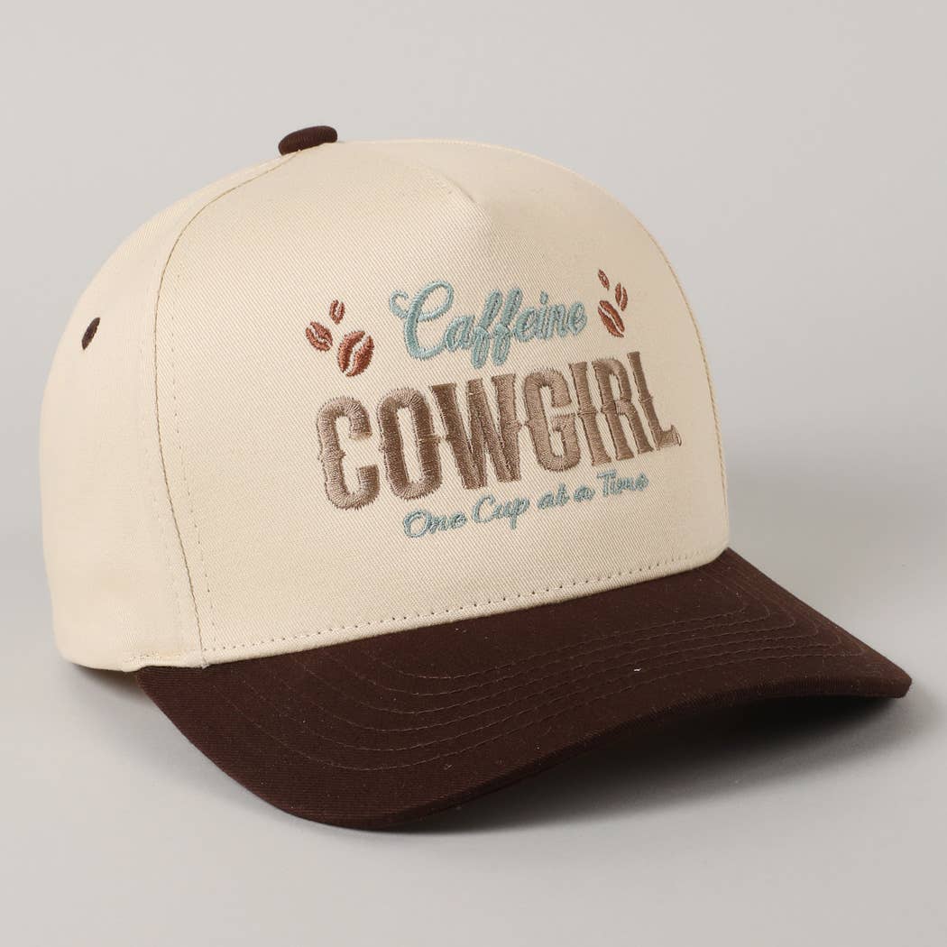 Cap with 'Caffeine Cowgirl One Cup at a Time' text and coffee bean graphics on a gray background
