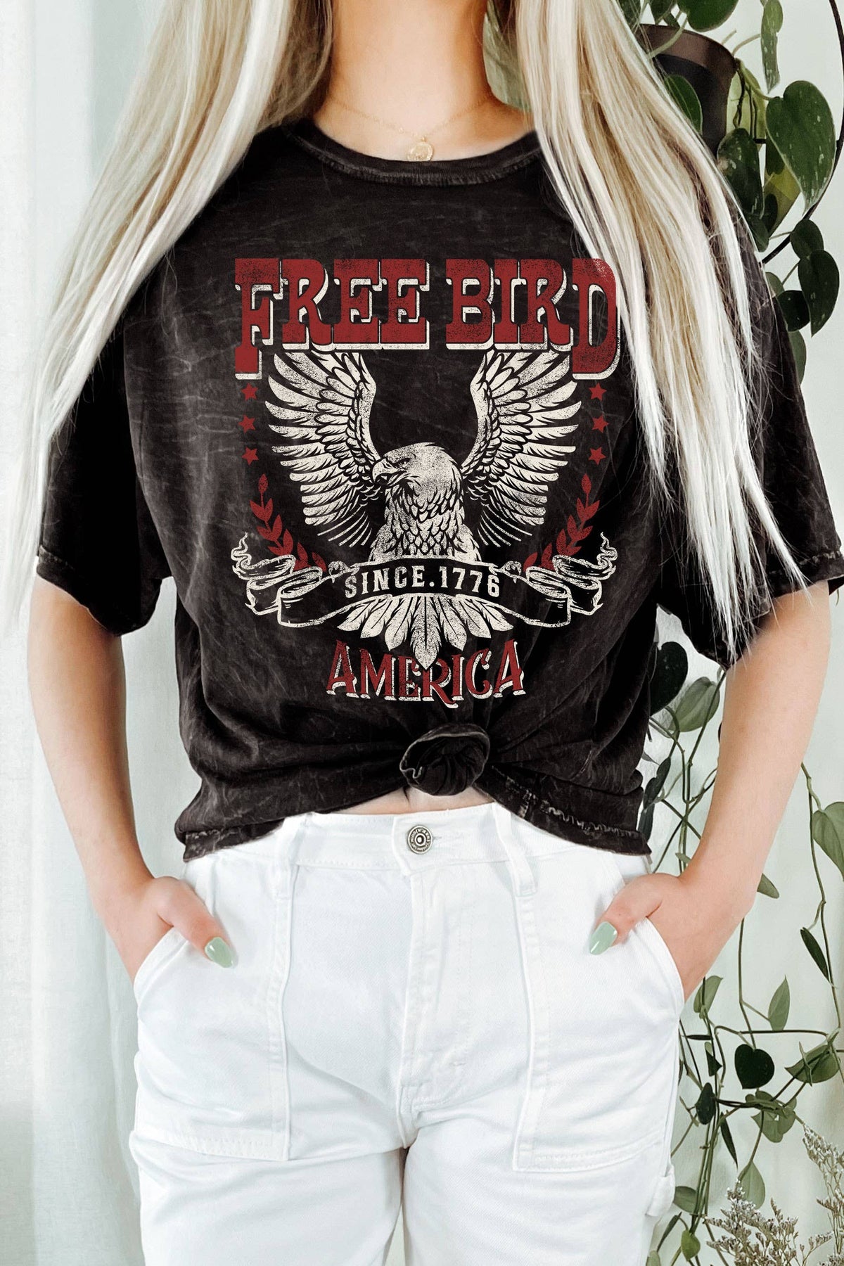 Person wearing a black t-shirt with 'Free Bird America' design, standing against a neutral background.