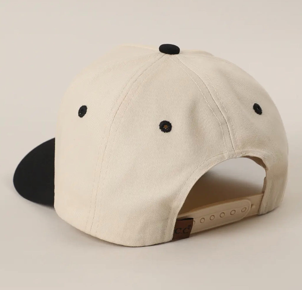 Beige cap with black buttons on a light gray background