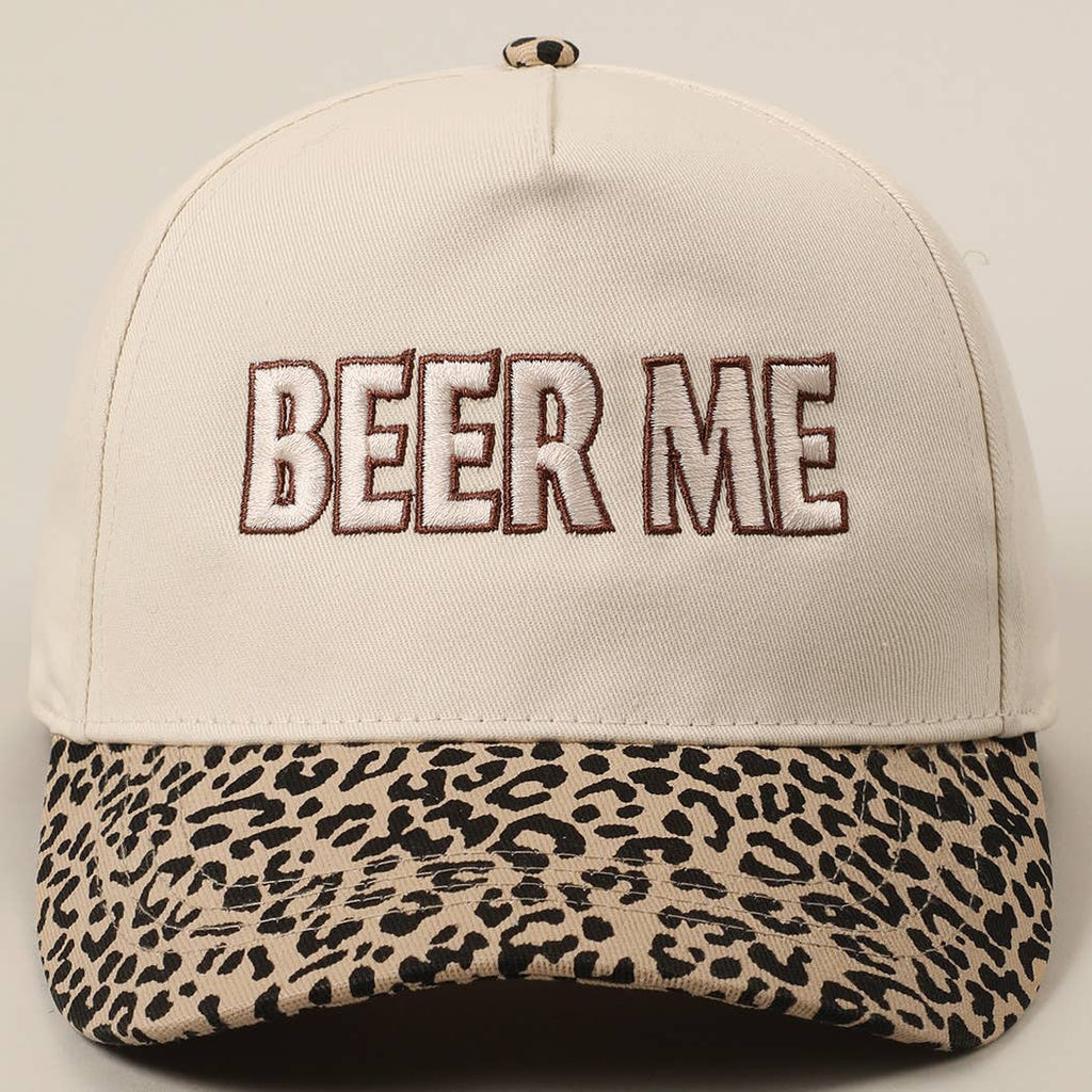 Beige cap with leopard print brim and 'BEER ME' text on a light gray background