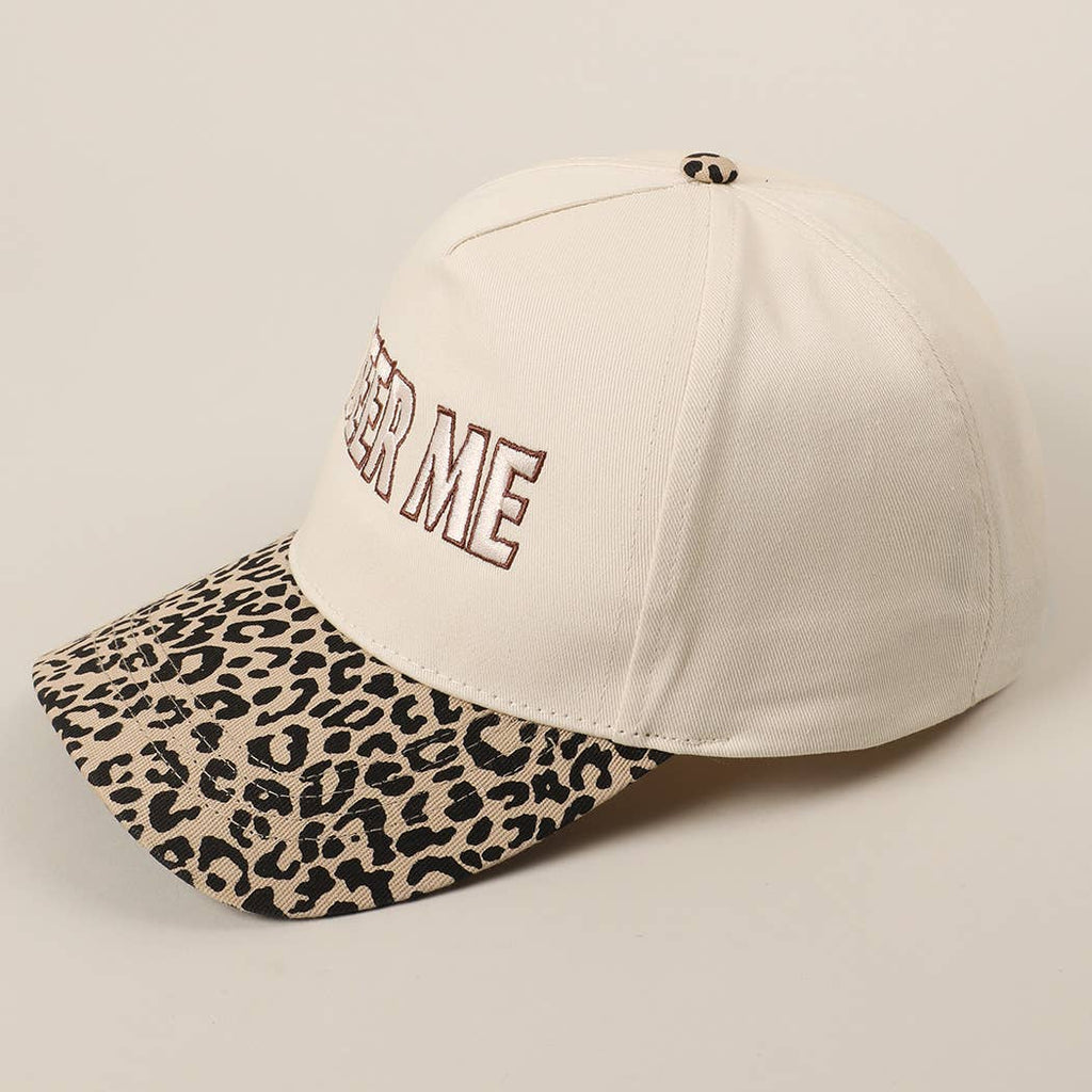 Beige cap with leopard print visor and 'FASTER ME' text on a beige background
