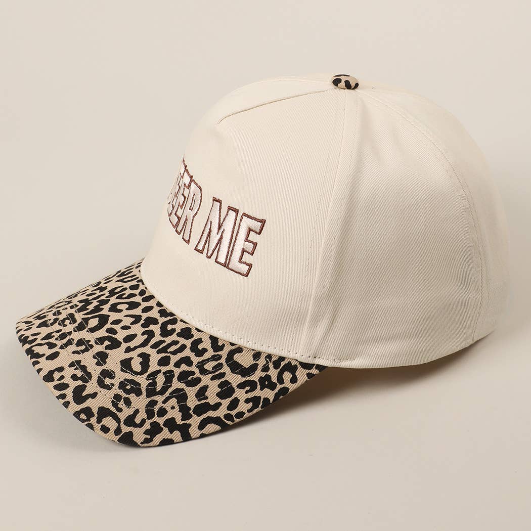 Beige cap with leopard print visor and 'FASTER ME' text on a beige background