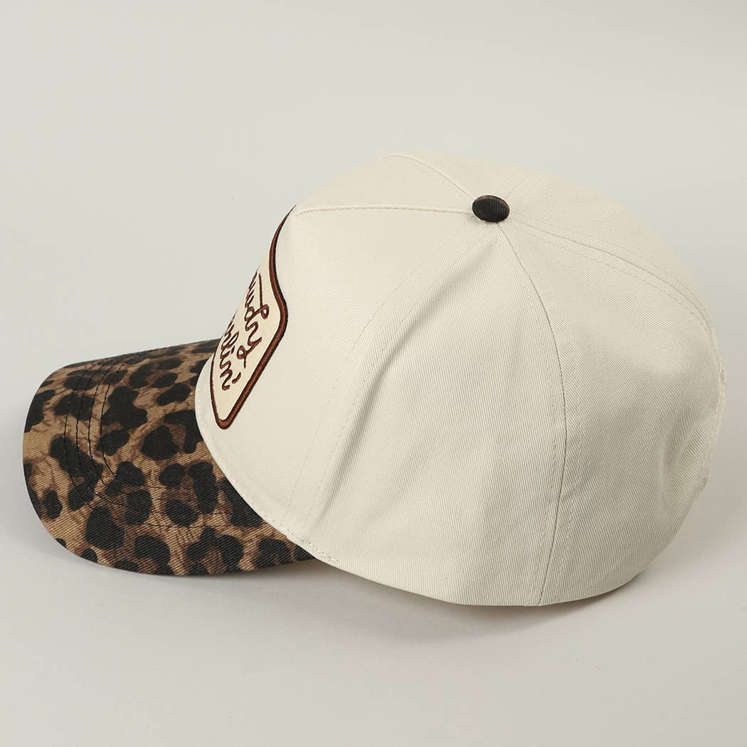 Beige cap with leopard print visor on a light gray background