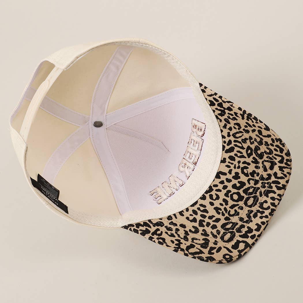 Cap with leopard print visor on a beige background