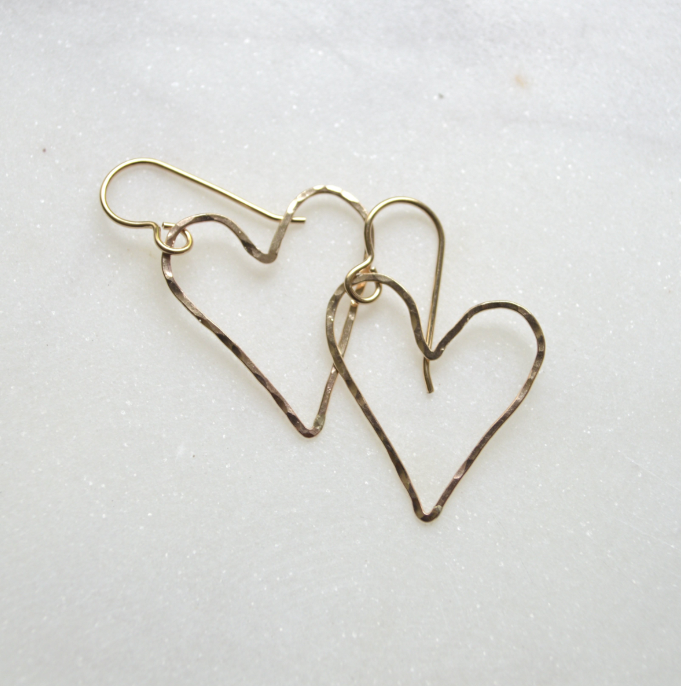 Heart-shaped earrings on a light background